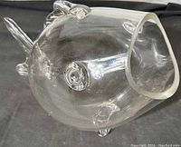 Clear crystal blown glass fish bowl with prominent eyes, fins, tail, and open mouth, resting on black fabric.