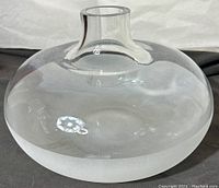 Side view of the large clear glass vase showing the rounded body and frosted base.