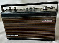 Front view of the vintage Nordmende Transita Royal radio showing its wooden slatted speaker panel and control knobs on top.