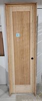 Front view of the bamboo interior door including frame, showing the natural bamboo finish and pre-cut holes for hardware.