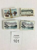 Five used Canadian postage stamps showing various landscape scenes including mountains, glaciers, and ocean waves. Each has legible text and circular cancellation marks.