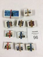 Multiple bundles of Canadian stamps secured with rubber bands laid out on a white surface.