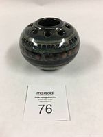 Front angled view showing round shape, surface and glaze.