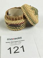 Opened miniature beargrass basket showing detailed weaving and color variations including red cedar section.