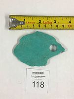 Natural turquoise slab with a circular hole near one edge, shown with measuring tape indicating length of about 3.25 inches.