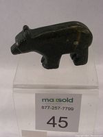 Side angle view of the dark green serpentine bear figurine showing natural stone variations and initials BB.