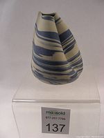 Front and side angles of the Robin Hopper vase showing the unique swirl pattern and irregular top shape.