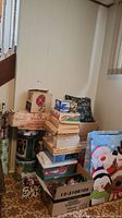 Overview of stacked boxes, gift wrap, tins, ornaments, gift bags, pillow