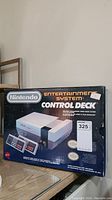 Front of original NES retail box showing control deck console and two controllers with price tag