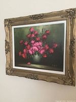 Full view of framed floral still life painting with pink and red roses in a greenish background