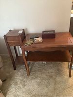 Wood furniture and coasters set against a wall and carpeted floor.