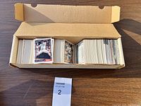 Box filled with several hundred baseball cards.
