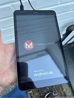 Front view of the Maxwest Nitro 8 Android tablet powered on showing startup screen with Maxwest and Android logos.