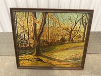 Full image of framed oil painting depicting an autumn wooded scene with a path and trees.