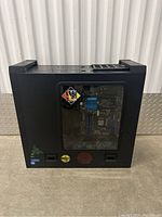 Side view of black gaming tower with transparent window showing internal components and external stickers.