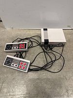 Image of COOLBABY Familycomputer System console with two wired controllers, showing front and cables.