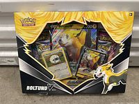 Front-facing image of the sealed Pokemon Boltund V collector's box showing the package contents and artwork.