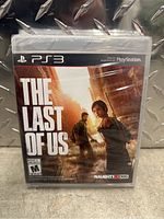Front cover of sealed PS3 game The Last of Us with original plastic wrap intact, showcasing the artwork and branding.
