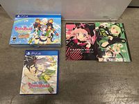 PS4 Senran Kagura Peach Beach Splash game case, special edition box, and two art books on floor