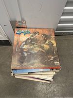 Top view of stack of vinyl records showing The Steely Dan Show album on top, record covers in varied condition