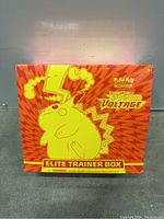 Front view of sealed Pokemon Sword & Shield Vivid Voltage Elite Trainer Box featuring Pikachu design on orange and yellow background