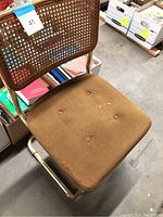 Front angle of chair showing seat cushion and partial cane back