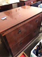 Frontal view of Kimball wood credenza showing two lateral file drawers with metal ring pull handles.