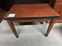 Top and front view of the wooden side table showing surface scratches and wear to the finish.