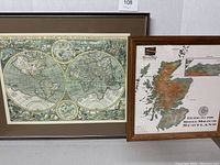Framed vintage-style world map and framed malt Scotland map side by side showing full contents.