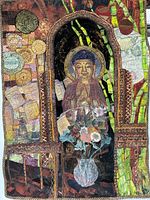 Full view of the quilted fabric wall hanging depicting Buddha with floral and bamboo elements.