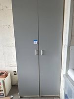 Front view of closed pair of tall melamine storage cabinets, showing two-door design and silver handles