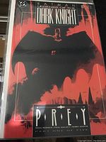 Photo of the Batman Legends of the Dark Knight comic book issue #34 with red and black cover, featuring Batman in shadow and 'Prey' subtitle.