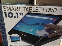Box showing product branding and image of 10.1 inch smart tablet with DVD