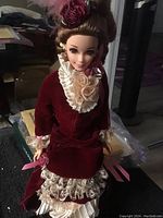 Close-up of Barbie doll's face and upper body in Victorian style dress showing lace and velvet details.