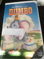 Front cover of VHS with Dumbo artwork and small wear damage