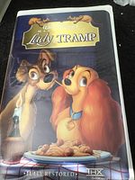 Front cover of VHS tape case showing Lady and the Tramp artwork with spaghetti plate and 'Fully Restored' and 'THX' logos.