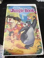 Front cover of The Jungle Book VHS case with colorful artwork of characters.