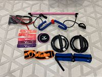Overview of all exercise items including resistance bands, weights, resistance bar, and ThighMaster style exerciser.