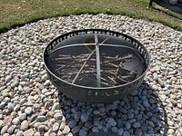 Fire pit shown from front angle on stone bed