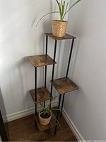 5 tier plant stand showing wood shelves and black metal rods, plants not included.