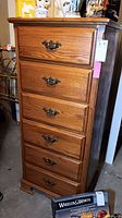 Front view of six drawer wood lingerie chest with antique style metal drawer pulls.