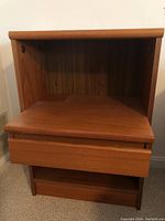 Front view of the nightstand showing drawer and open shelf.