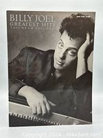 Front cover of the Billy Joel sheet music book showing a black and white photo of Billy Joel leaning on a piano.