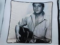 Front view of throw cushion showing black and white Elvis Presley image and black piping border.