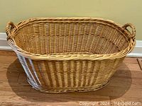 Front view of the extra large oval wicker basket showing overall shape and structure.