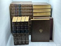 Complete set of Encyclopedia Britannica volumes stacked showing spines and covers.