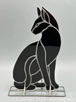 Front view of the stained glass black cat figurine showing the shape and glossy black glass panels with silver outlines.