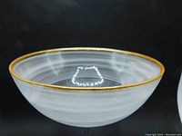 Side profile view of the bowl showing the alabaster white swirling pattern and gold rim
