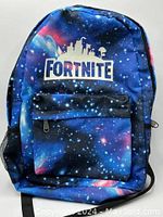 Front view of the Fortnite backpack showing galaxy-themed print and front zippered pocket.