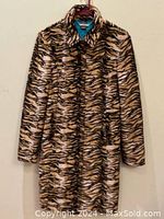 Front view of Guess animal print coat hanging on hanger, showing full length and pattern of coat.